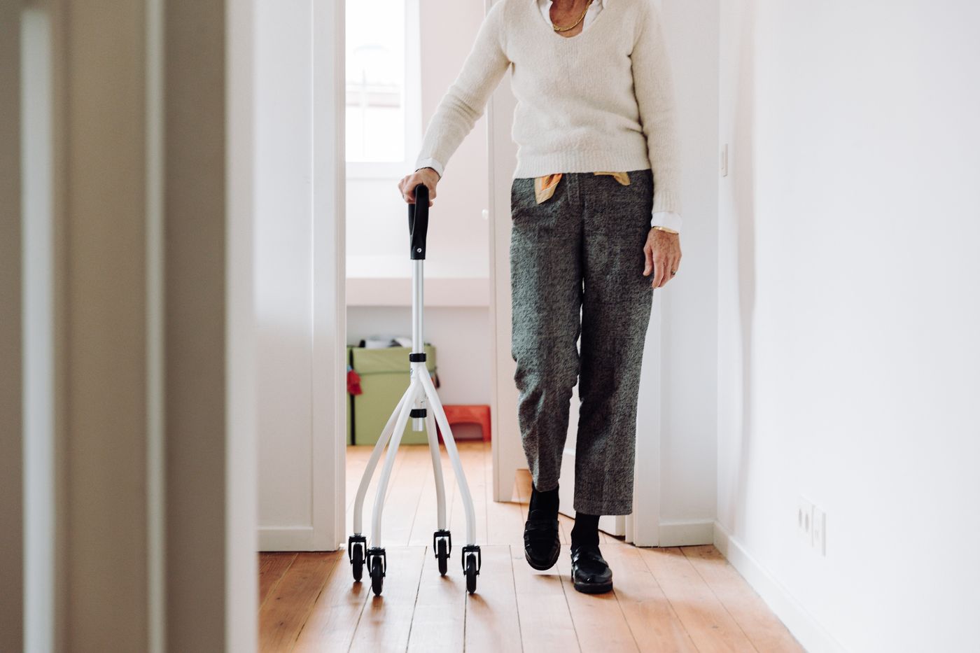 Elderly patient using a walking frame at home